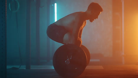 Athletic-Shirtless-Man-Training-Doing-Power-Strength-and-Endurance-Exercises-with-Barbell.-Workout-in-the-Hardcore-Gym-in-slow-motion